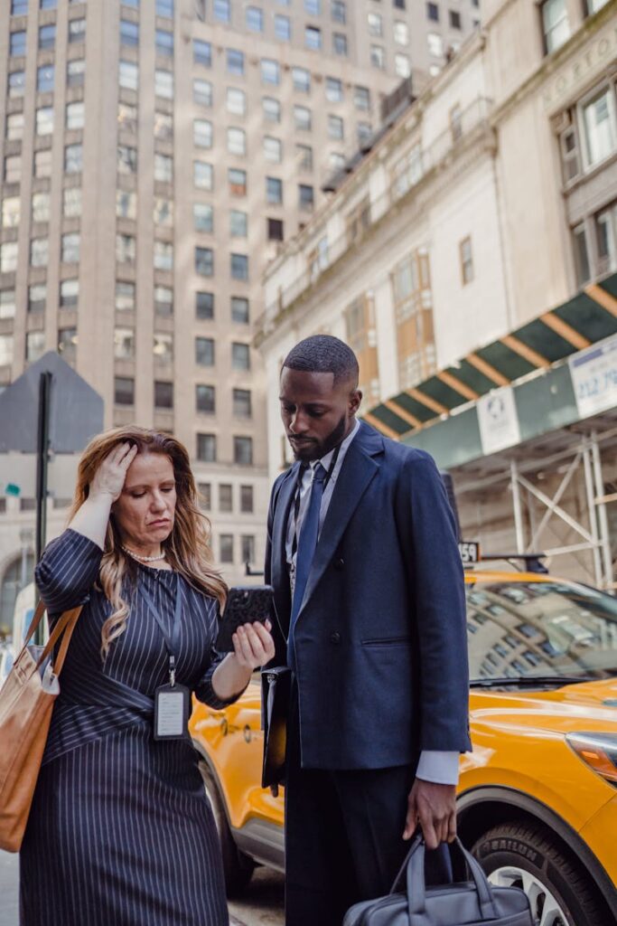 Two People Talking on the Street and Looking at the Phone